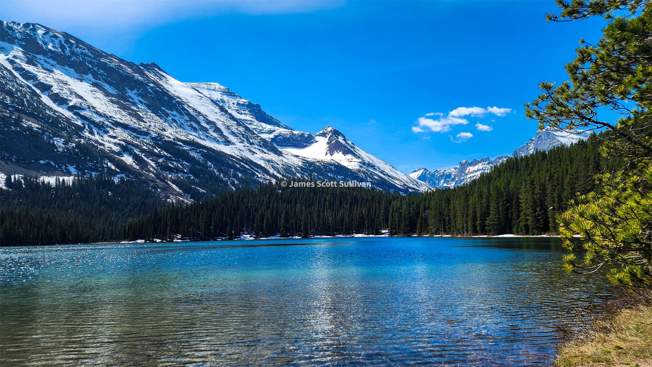 Glacier lake and snow-covered peaks during the Chapter 4 westward stretch.