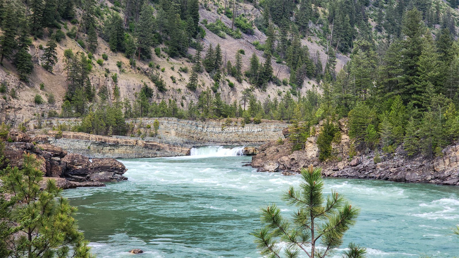 Blue-green water churning through Kootenai Falls.