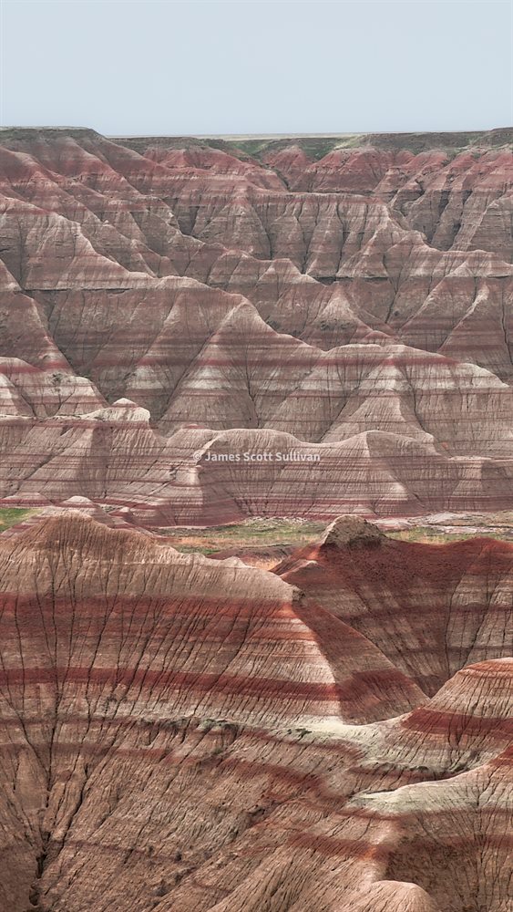 Layered rock formations in Badlands National Park.