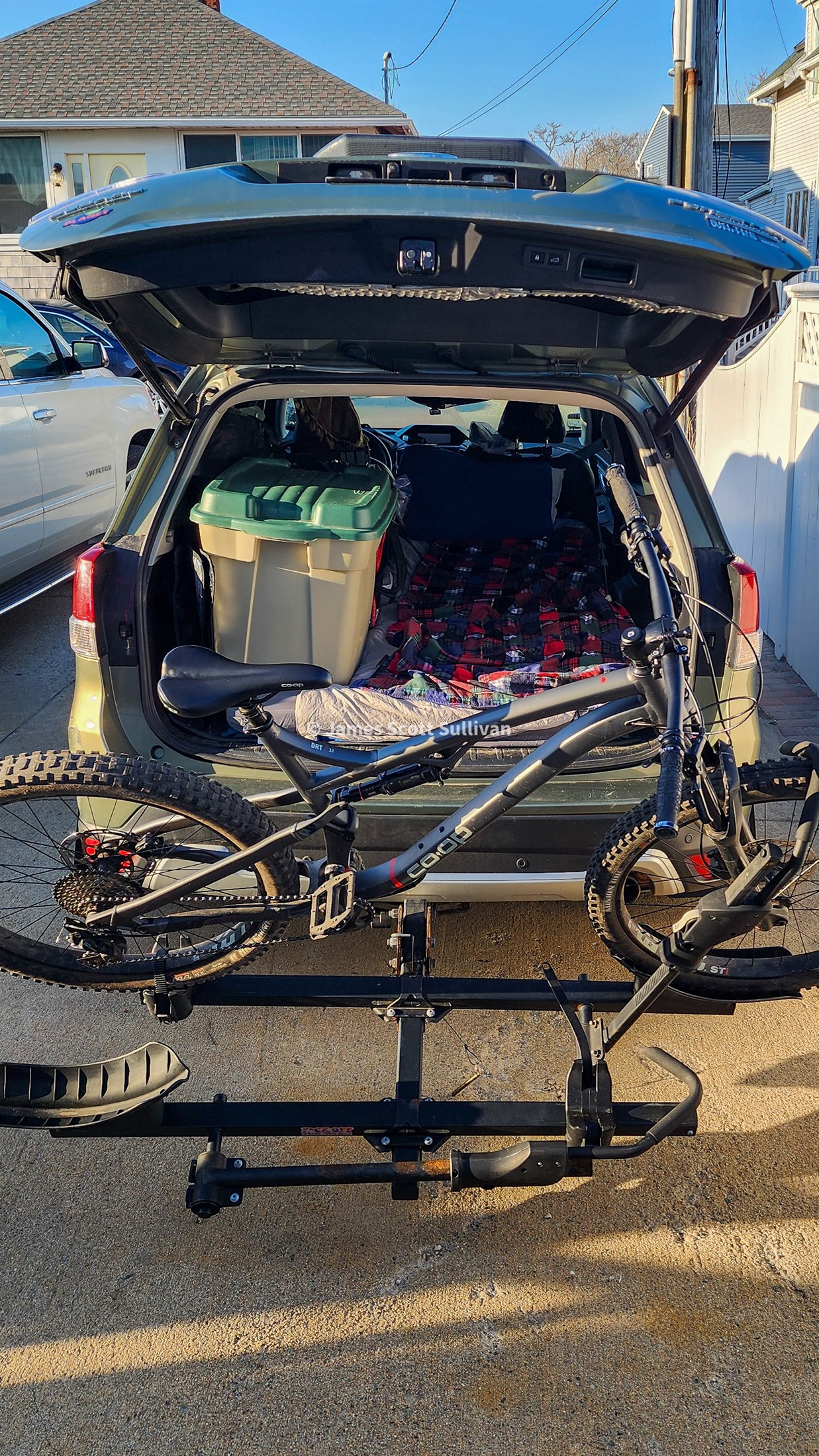 A packed Subaru with a mountain bike mounted on the back at the start of the road trip.