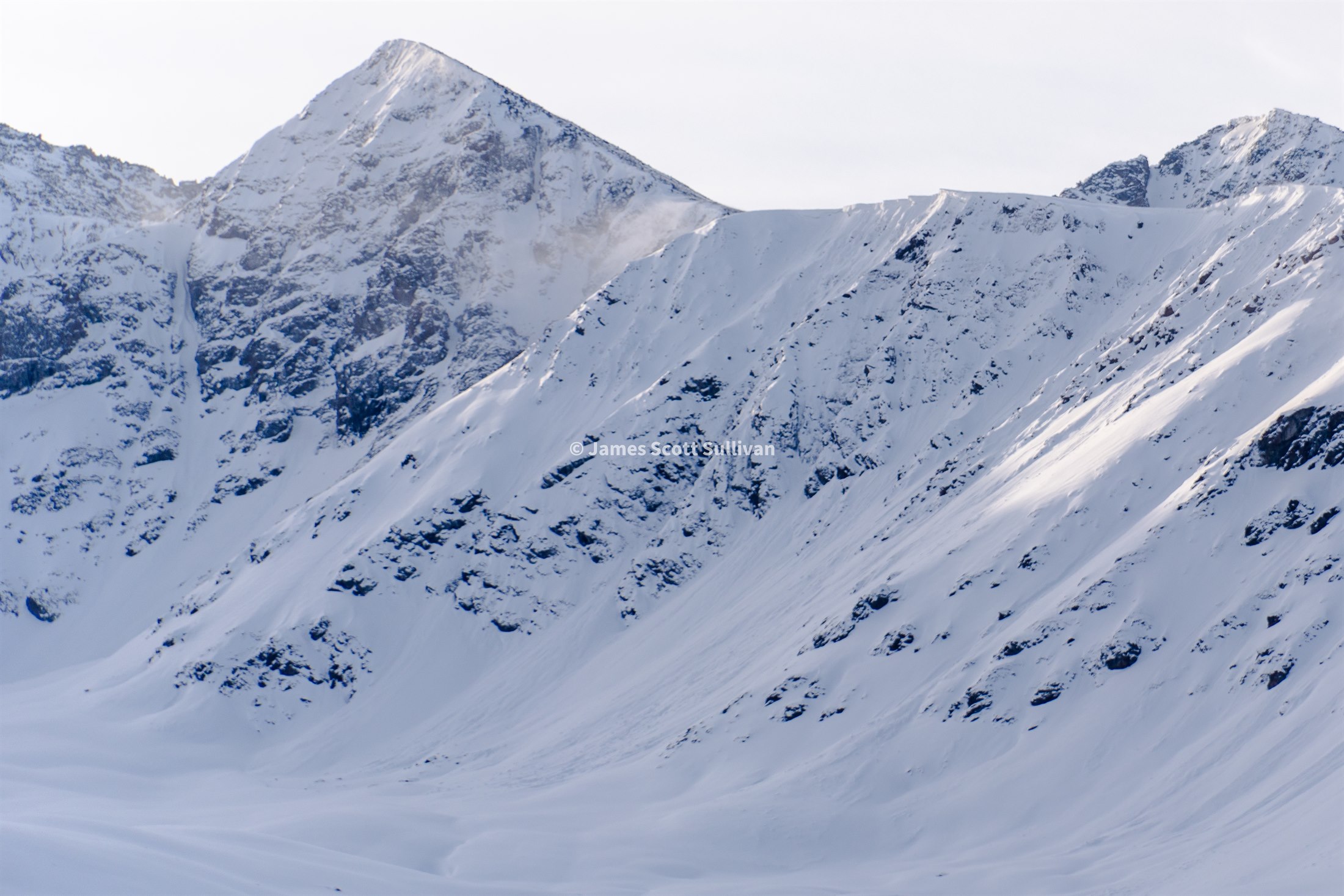 Wind blowing from a snowy ridgeline in the Jyrgylan Heights of Kyrgyzstan.